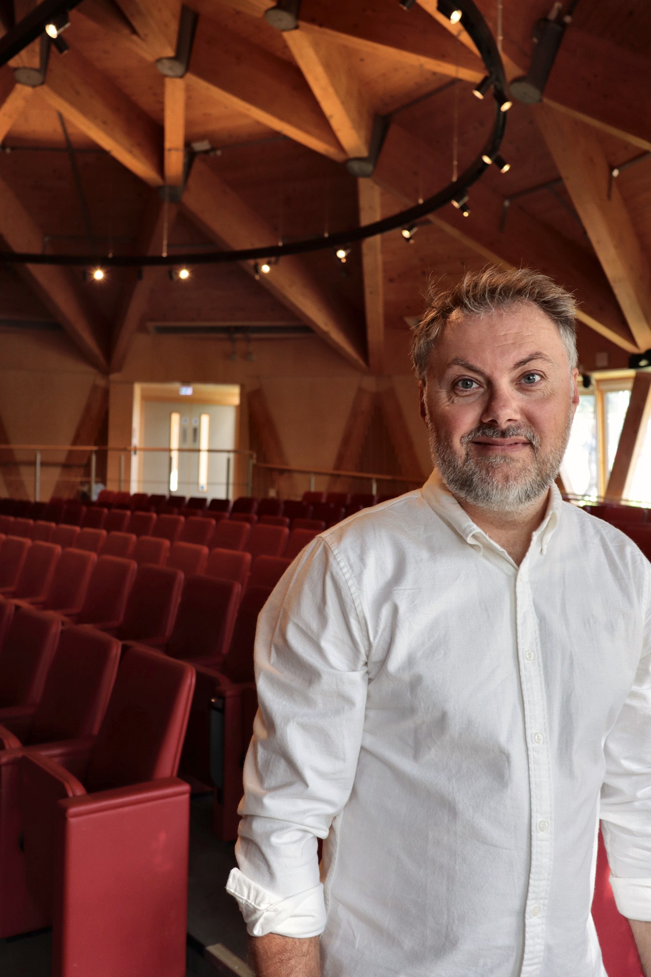 Dr John P. Mills standing in an auditorium