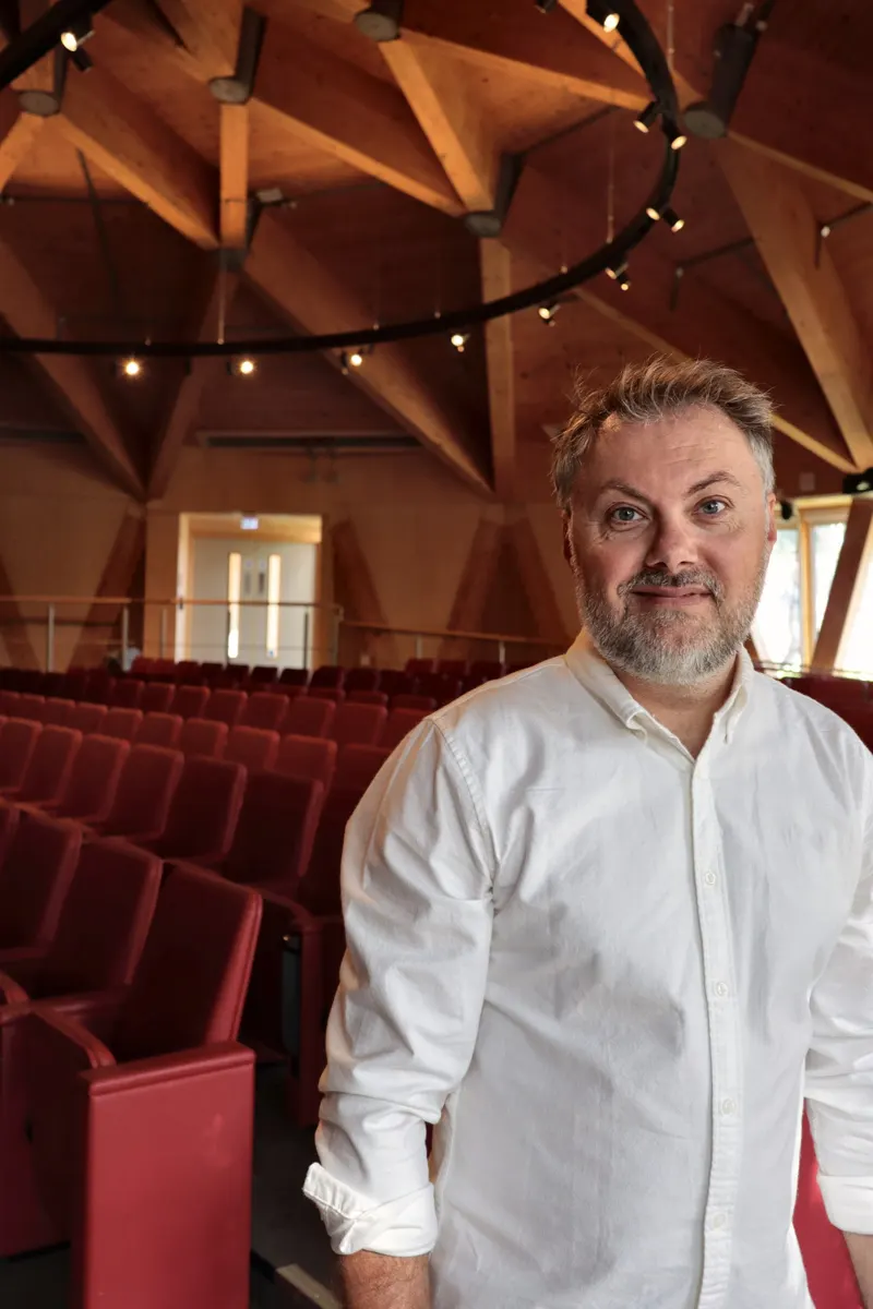 Dr John P. Mills, behavioural scientist, in a university lecture theatre